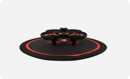 Rocket Drones classroom drone on a circular red and black landing pad used for STEM flight training.